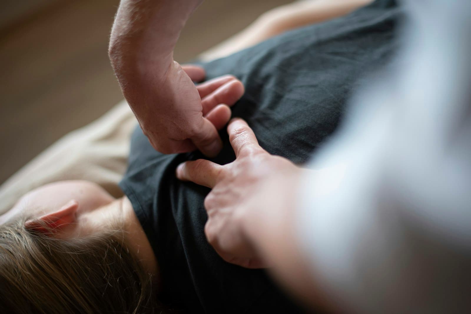 Finger-pressure massage performed through clothing