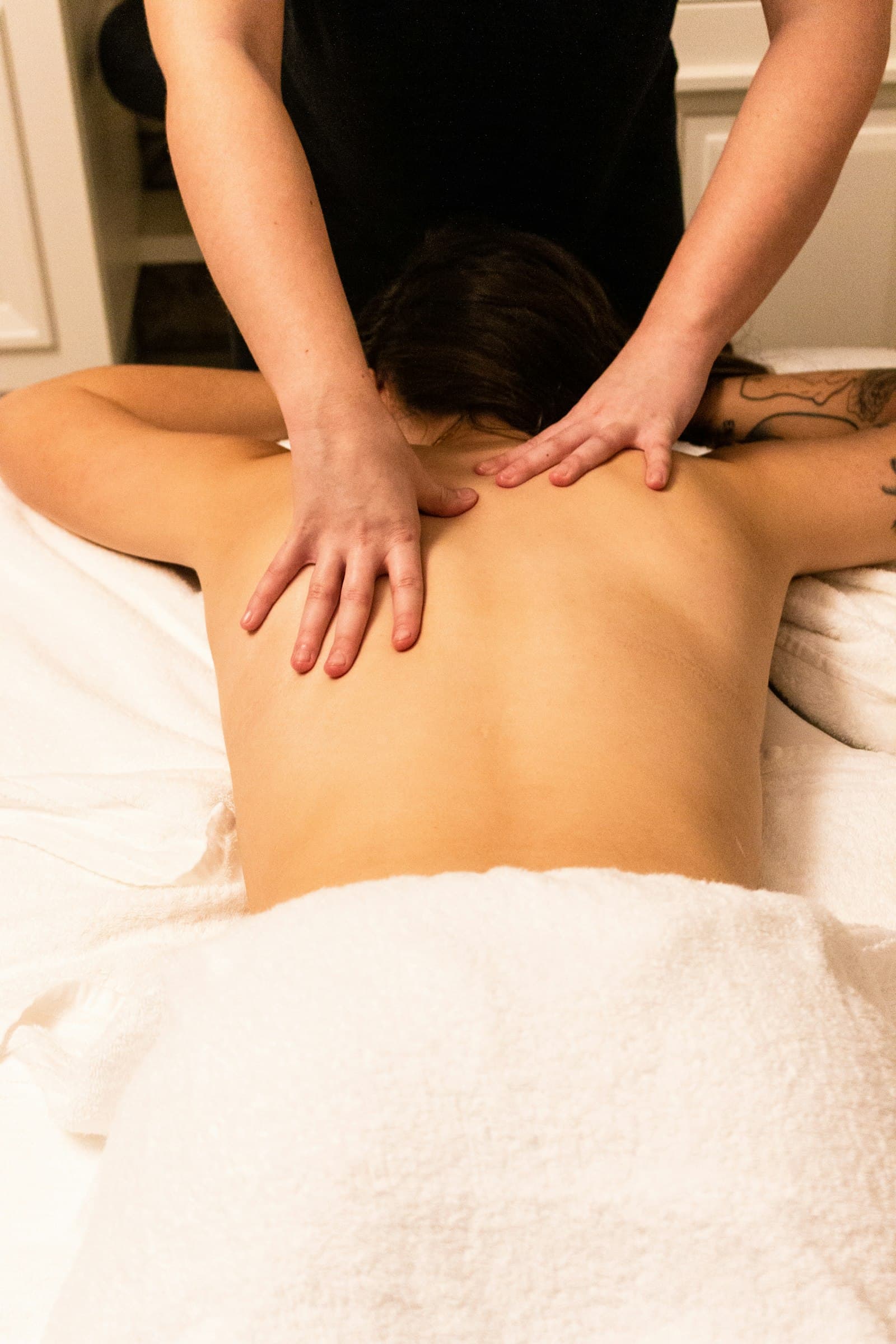 Long, flowing massage strokes across the back