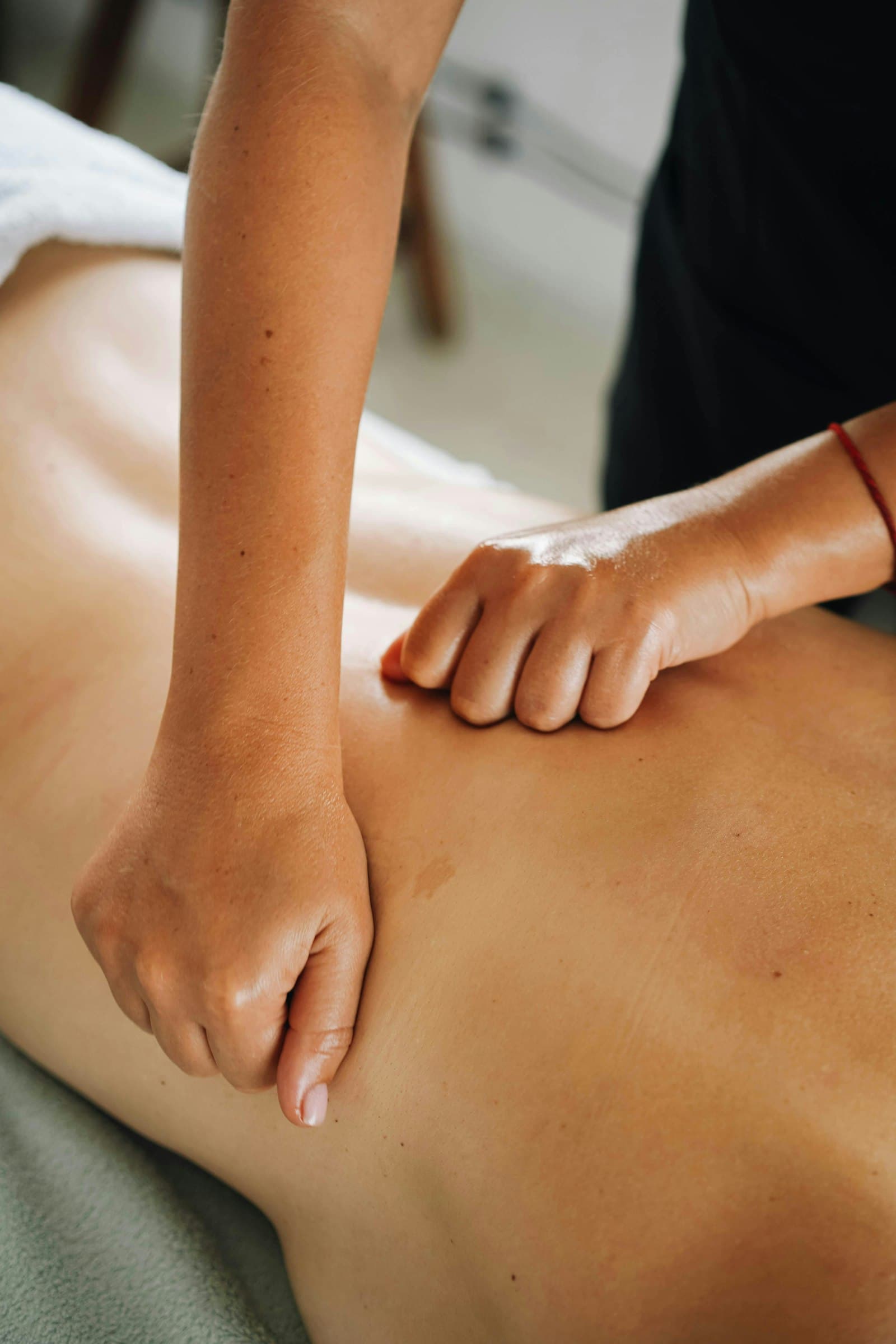 Firm compression massage along the back